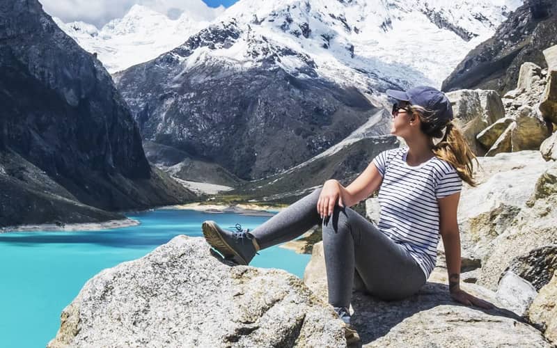 Woman Sitting on Rock by Lake